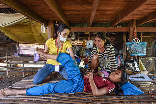 Arunny receiving physiotherapy to her legs