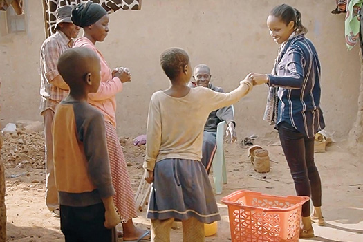 Ingabire talking with children and their parents