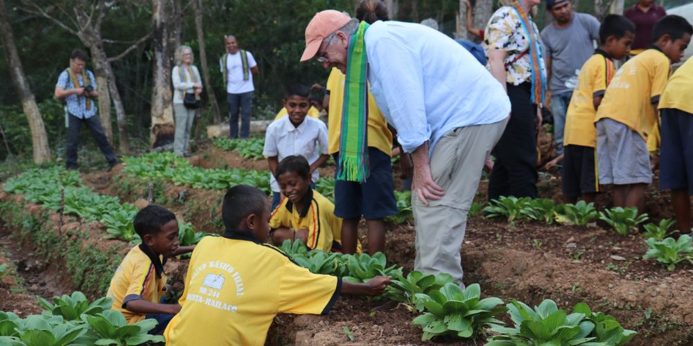 James talking to children in their veggie patch